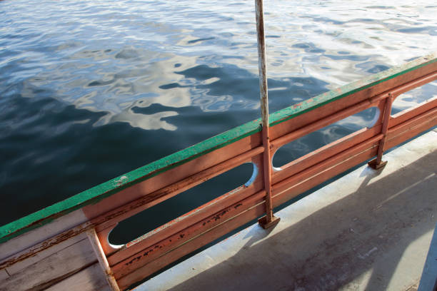 istock Boat with wooden railing in the sea 884066268