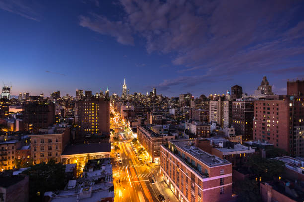 istock Manhattan After Sunset with Sixth Avenue Glowing 884069796