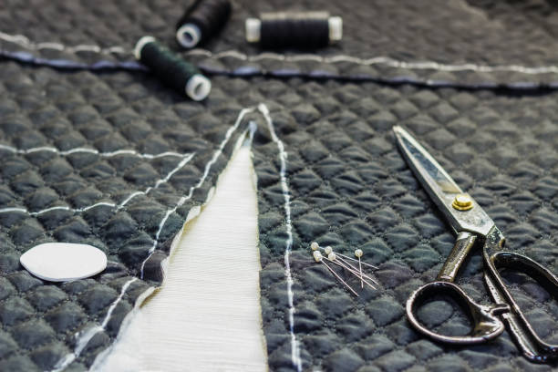 istock Workplace tailor. On the table close-up lie the samples of fabrics, scissors, thread, balac, roulette and buttons. 884076324