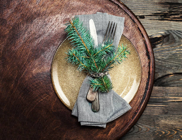 istock Creative Christmas idea with table setting on bright wooden table. Christmas card with cutlery, copyspace 884079278