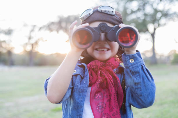 istock Curious little girl uses binoculars 884083198