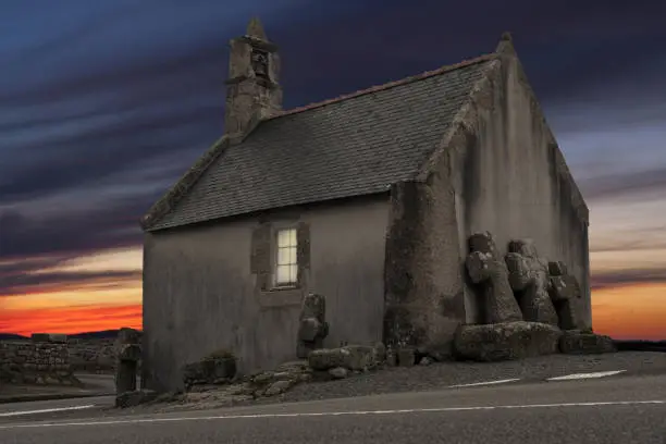 Photo of Like a tail: beautiful small chapel after sunset on a stormy day in France, Croazou