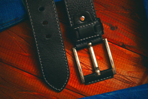 istock black leather belt with buckle stitched with white thread, close-up top view 884095408