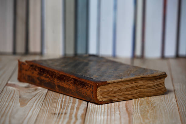 Vintage old books on wooden deck table and grunge background. Copy space.