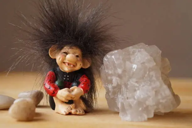 A troll cute with a salt crystal and stones