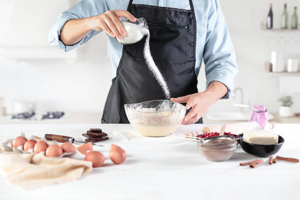 istock A cook with eggs on a rustic kitchen against the background of men's hands 884105640