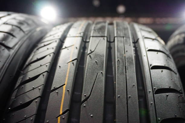 istock New car tire profile on black background 884106916