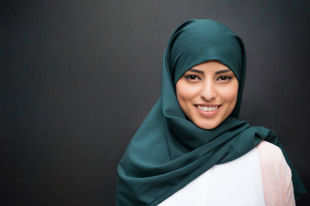 Smile From The East Portrait of a beautiful smiling muslim woman wearing hijab. hijab photos stock pictures, royalty-free photos & images
