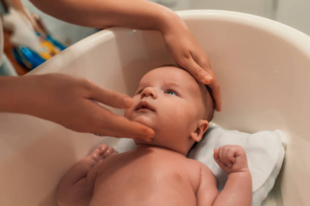 istock Newborn baby in bathtub 884116228