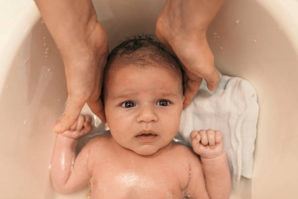 istock Funny face of baby taking bath 884116380