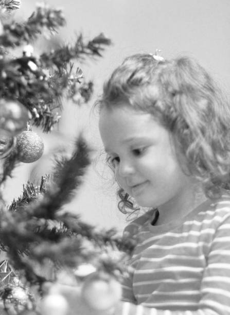 istock Girl is decorating the Christmas tree 884130450
