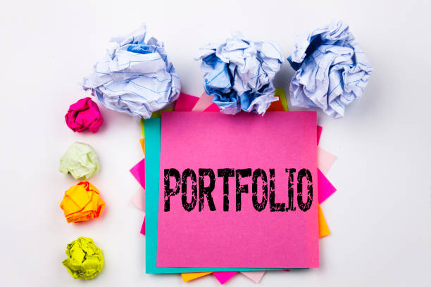 istock Writing text showing Portfolio written on sticky note in office with screw paper balls. Business concept for Business Marketing Design on the white isolated background. 884130474