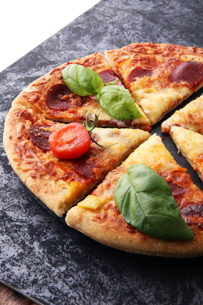 istock Hot Homemade Pepperoni Pizza Ready to Eat with basil 884141262