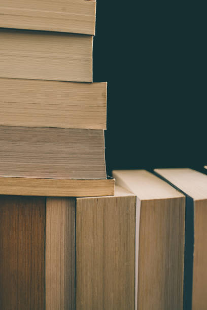 istock Books background. Old vintage books background. Education and knowledge, learn, study and wisdom concept. Stack of old books. Old books on a shelf. Stacked old books in vintage style. 884143940