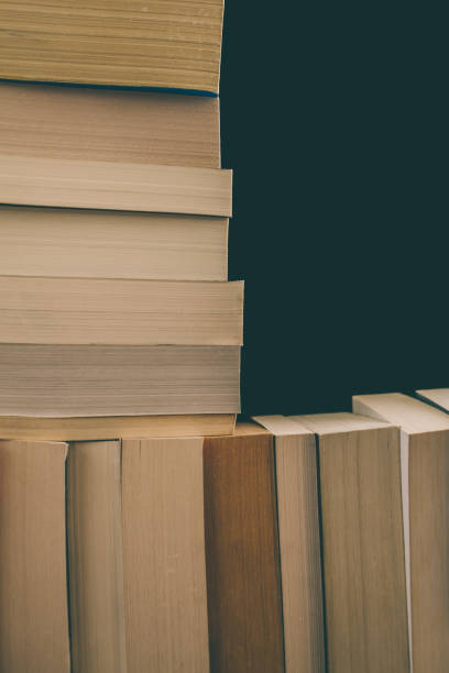 istock Books background. Old vintage books background. Education and knowledge, learn, study and wisdom concept. Stack of old books. Old books on a shelf. Stacked old books in vintage style. 884143944