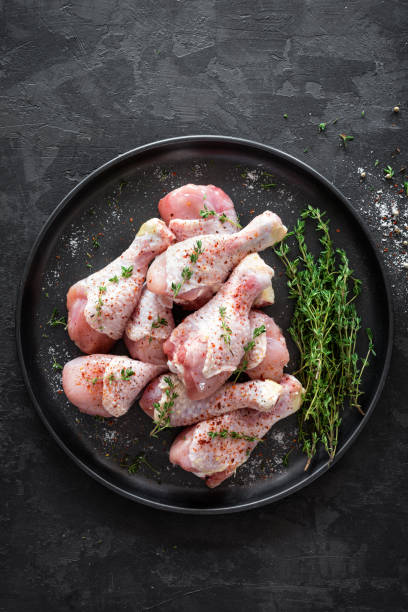 istock Raw marinated chicken meat, chicken legs 884148170