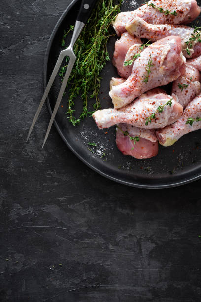 istock Raw marinated chicken meat, chicken legs 884148272