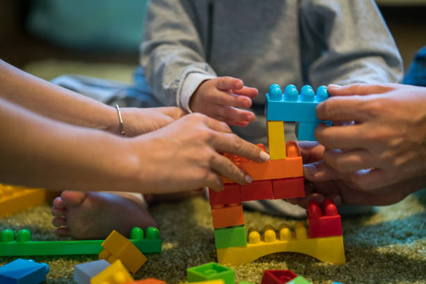 istock A helping hands with making house of plastic blocks 884148688