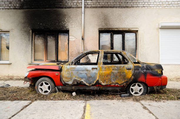 Burnt red car after fire accident Burnt red car after fire accident side view beat up car stock pictures, royalty-free photos & images