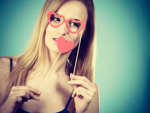 istock Woman holding carnival accessoies on stick 884154446