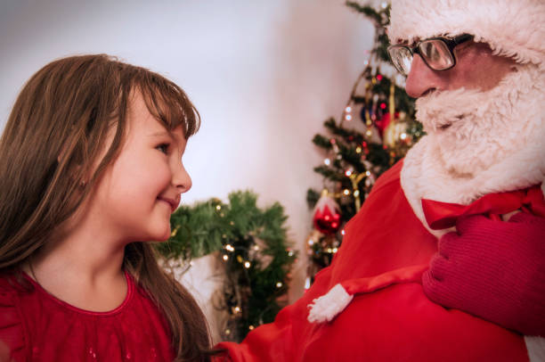 mi santa - whispering grandparent child grandfather fotografías e imágenes de stock