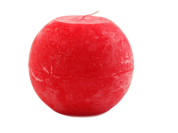 istock Red wax candle with a wick on a white background 884194728