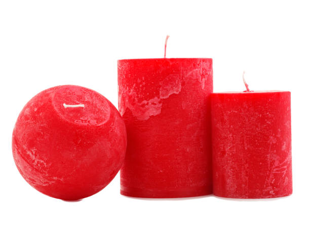 istock Three red wax candles isolated on white background 884194878