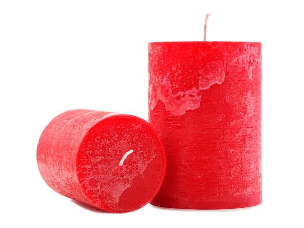 istock Two red wax candles different in diameter and length isolated on white background 884196998