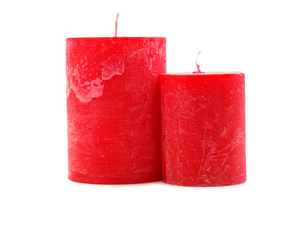 istock Two red wax candles different in diameter and length isolated on white background 884197092