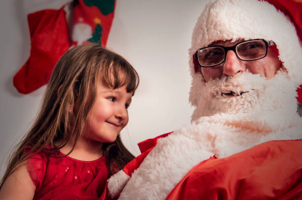 mi santa - whispering grandparent child grandfather fotografías e imágenes de stock