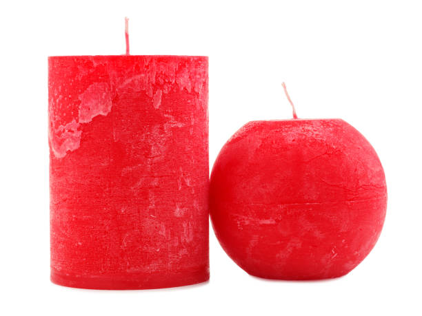 istock Two red wax candles different in diameter and shape isolated on white background 884197204