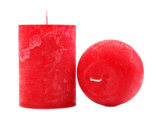 istock Two red wax candles different in diameter and shape isolated on white background 884197894