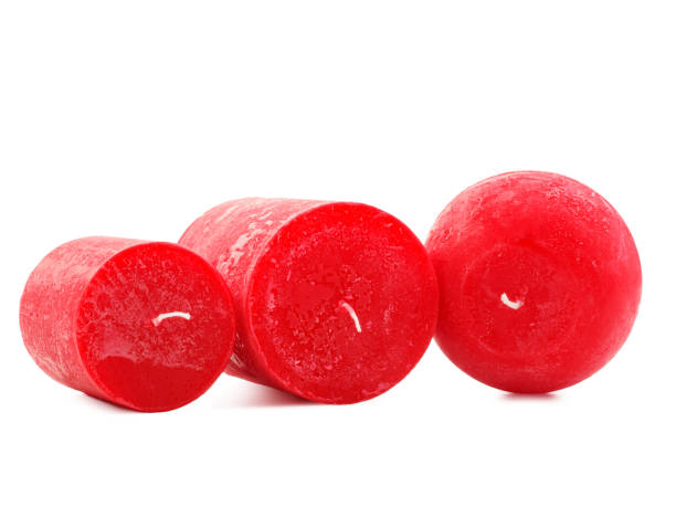 istock Thick red wax candle with a wick on a white background 884198062