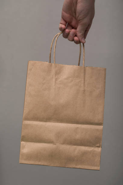 istock Brown Paper Bag Carry Hand 884198440