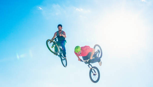 istock Two freestyle cyclists in mid-air 884203652