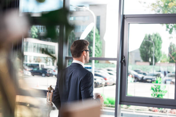 istock businessman drinking coffee in office 884203964