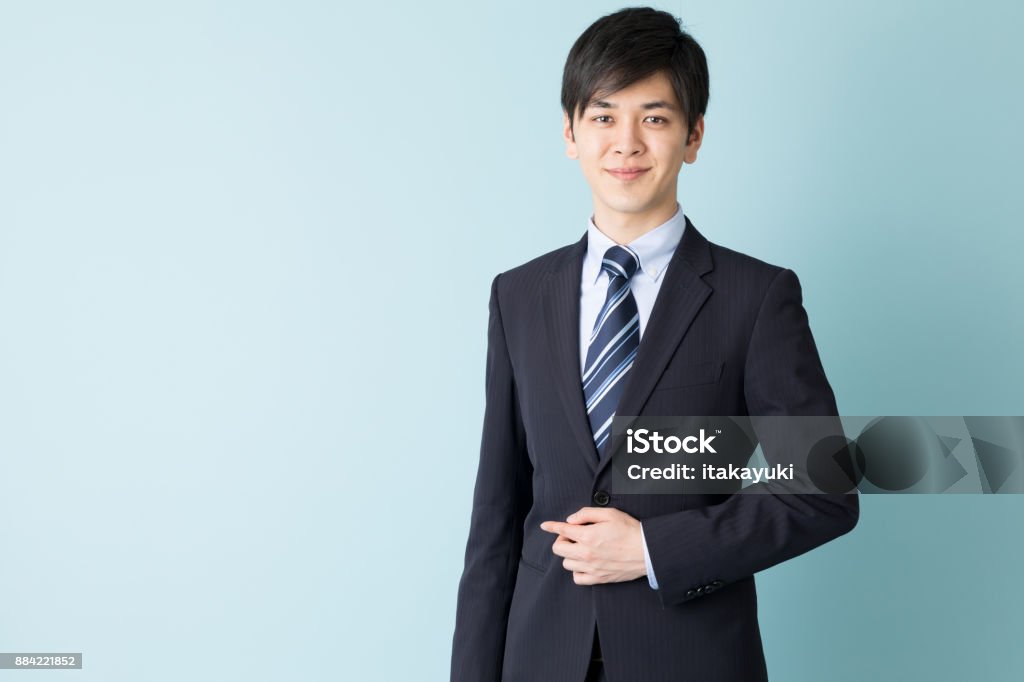 portrait of asian businessman isolated on blue background Suit Stock Photo