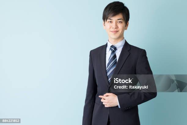 Portrait Of Asian Businessman Isolated On Blue Background Stock Photo - Download Image Now
