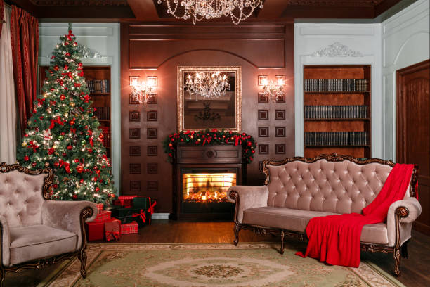 istock Christmas evening. classic apartments with a white fireplace, decorated tree, sofa, large windows and chandelier. 884236692