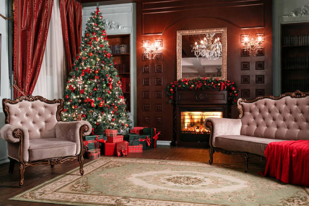 istock Christmas evening. classic apartments with a white fireplace, decorated tree, sofa, large windows and chandelier. 884236800