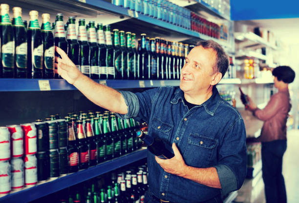 istock Pensioner selecting a beer at the  store 884273492