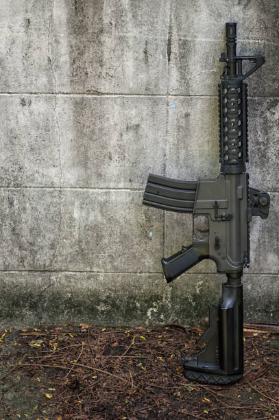 istock Terrorist hostage threatened women with guns against the wall. 884290452