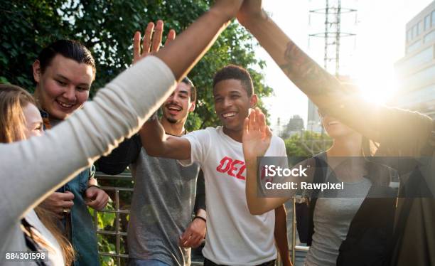 Friends Giving High Fives Stock Photo - Download Image Now - Teenager, Community, Young Adult