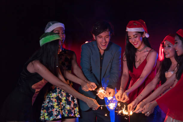 istock Cheering crowd young people at New Year - holiday celebration background 884306282