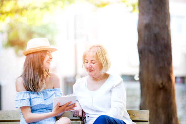 istock Smiling mother with young daughter with digital tablet 884306426
