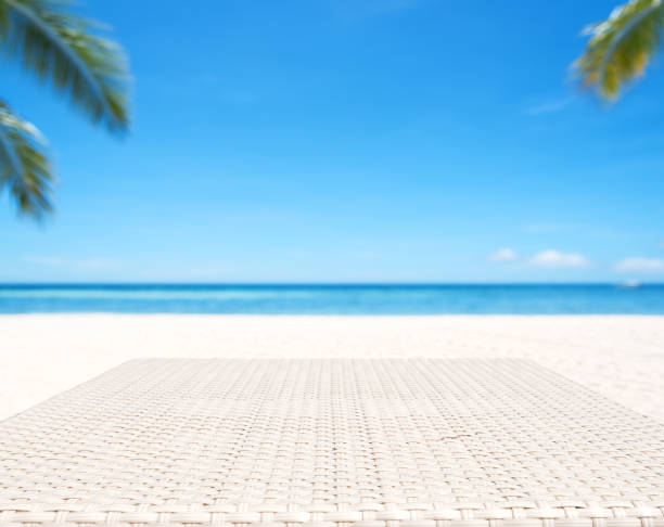 istock Wood weave table surface with tropical beach background 884312064