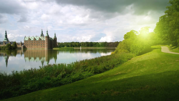 Frederiksborg castle in Denmark - the castle on the left, to the right a bright green lawn stock photo