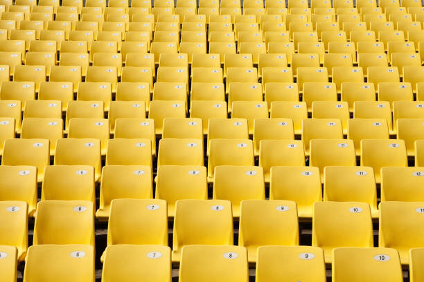sedili gialli nello stadio - bleachers stadium seat empty foto e immagini stock