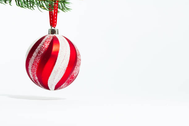 istock Red christmas striped pattern ball in hang a tree 884355714
