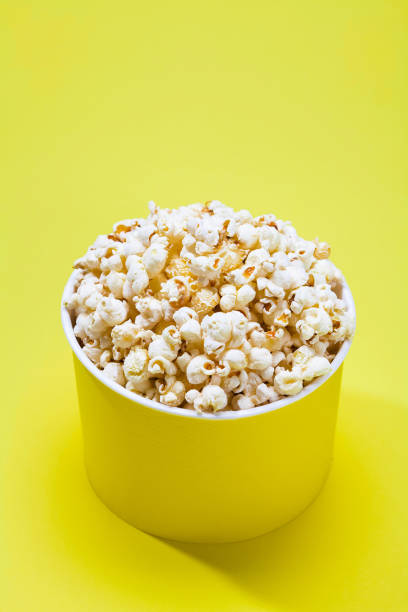 istock Yellow background of popcorn in a pack 884358562